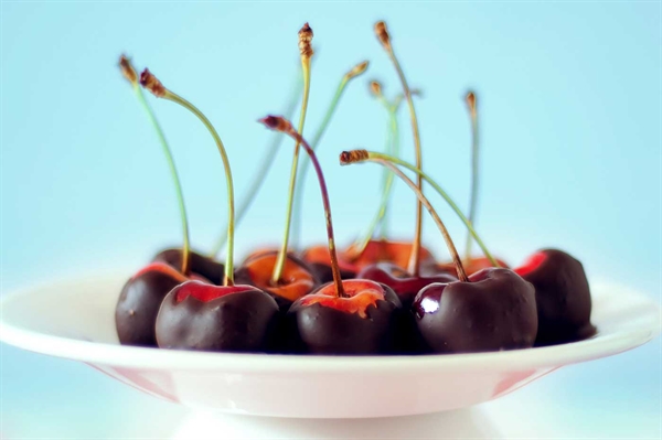 Chocolate-coated Maraschino Cherries Sprinkled with Macadamia Nuts